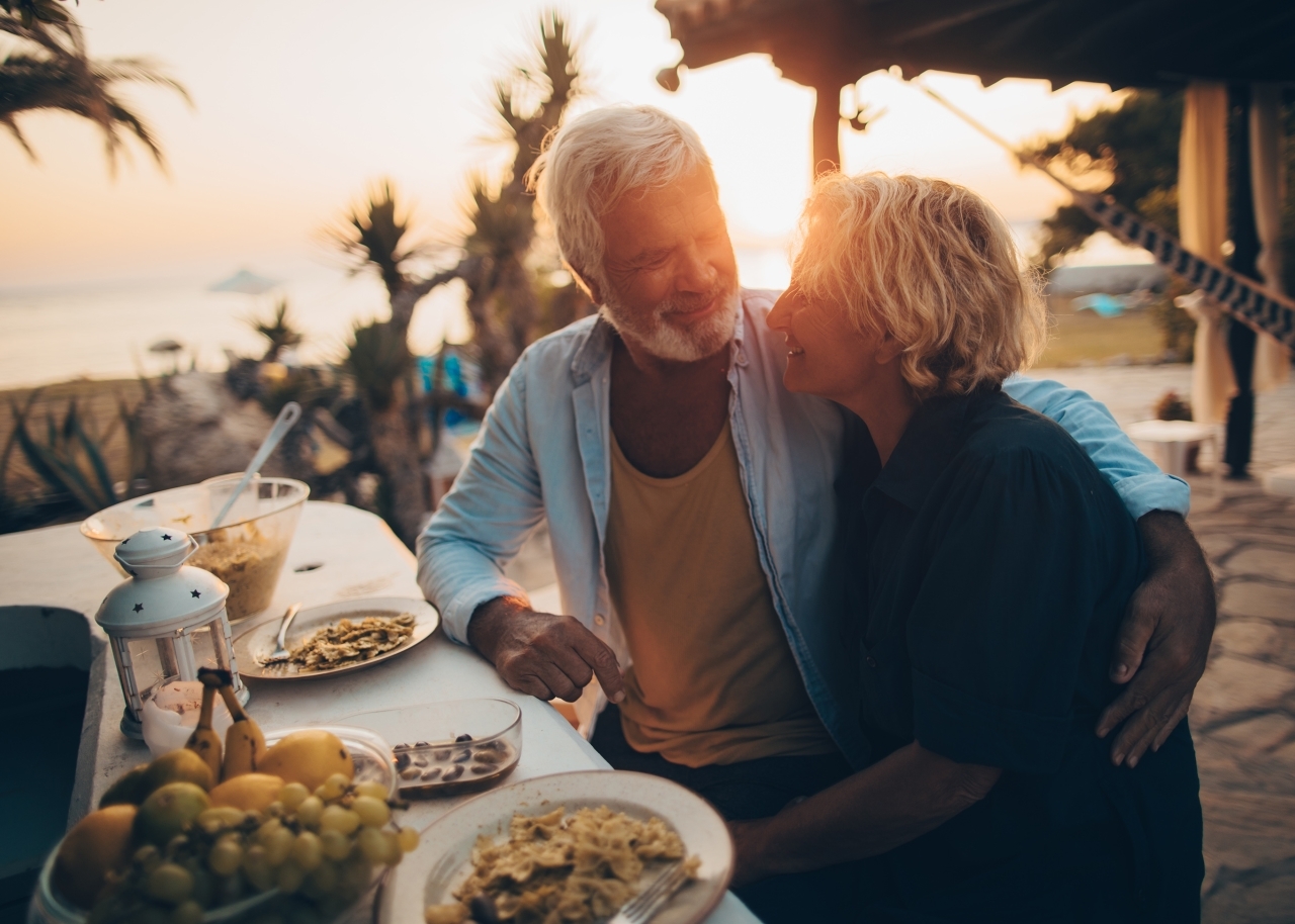 Senior couple having dinner at the beach